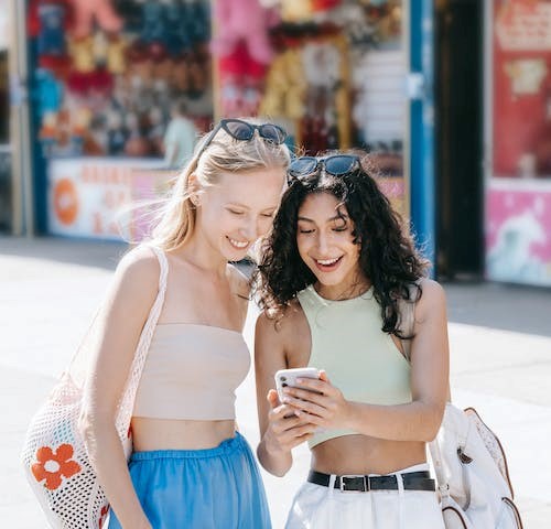 friends looking at the mobile phone happily