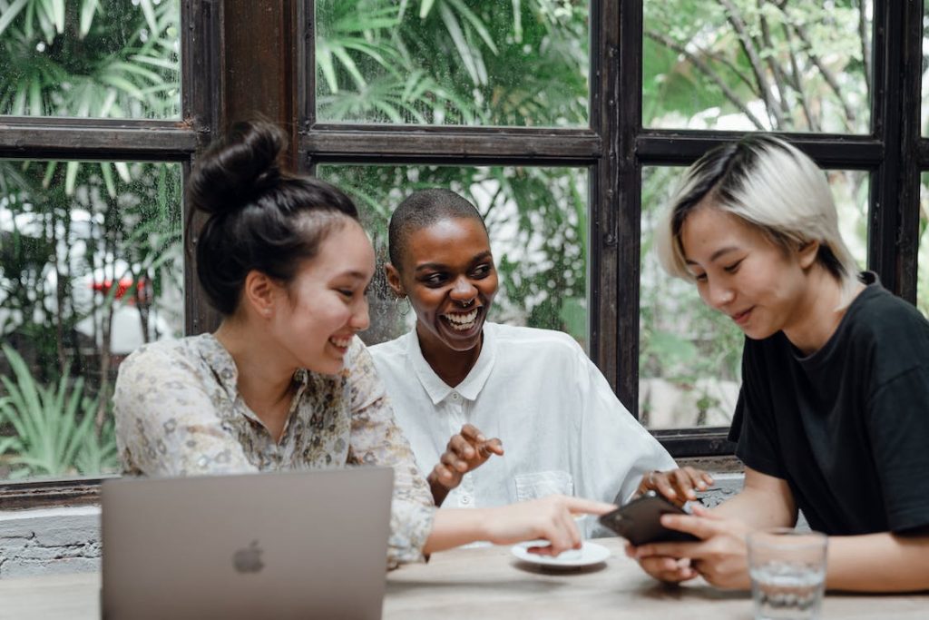 a group of friends looking at the smartphone