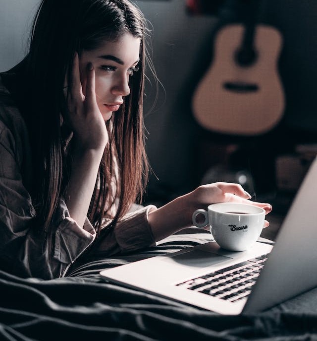 How to Delete Tripadvisor Account featuring a girl looking at the laptop screen