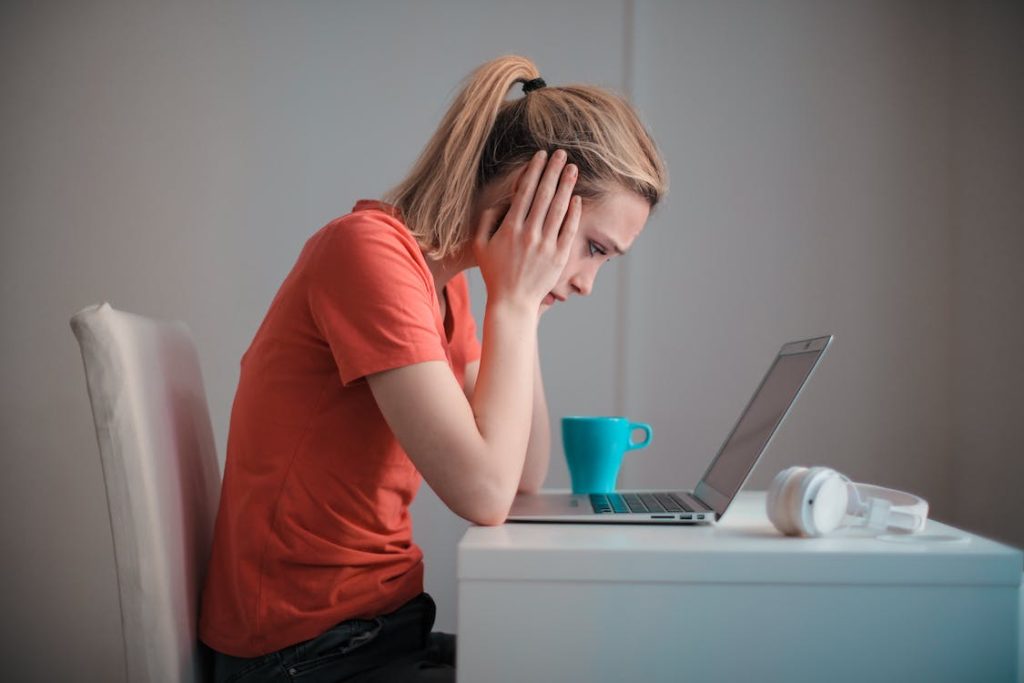 girl worried looking at the laptop screen