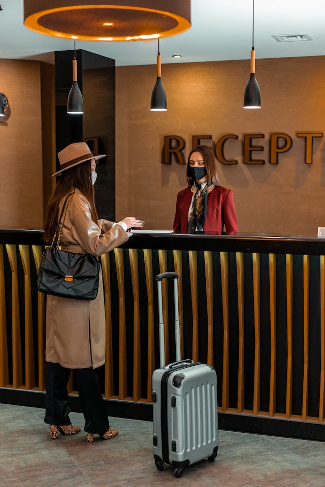 lady checking in at hotel reception