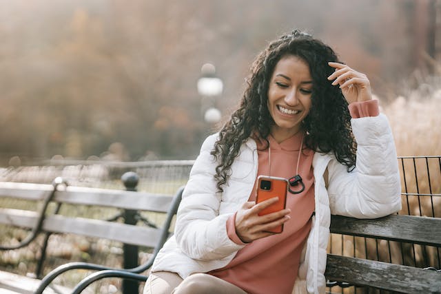 lady smiling while browsing phone