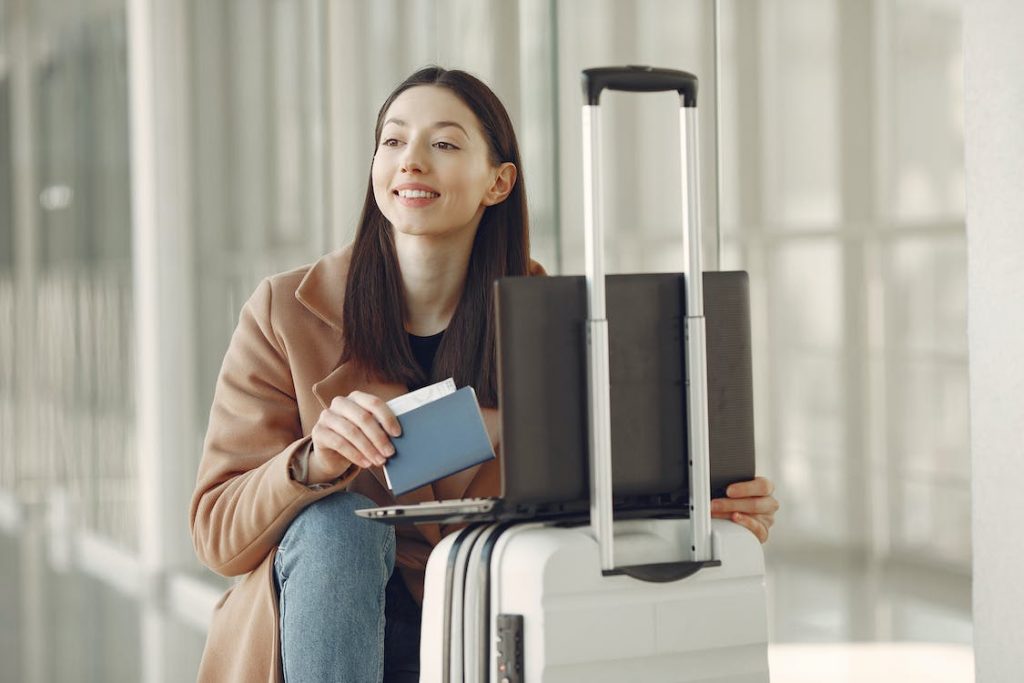 lady traveling with laptop and suitcase