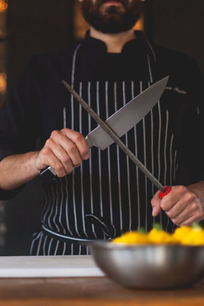 chef sharpening a knife