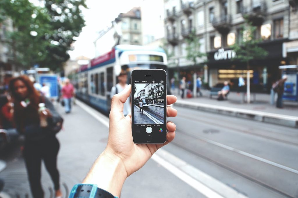 How to Edit Tripadvisor Review featuring someone taking a photo on a street