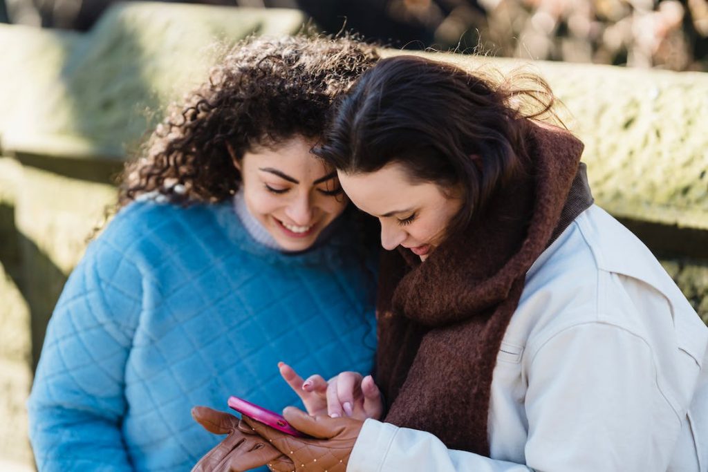 two friends looking at the smartphone