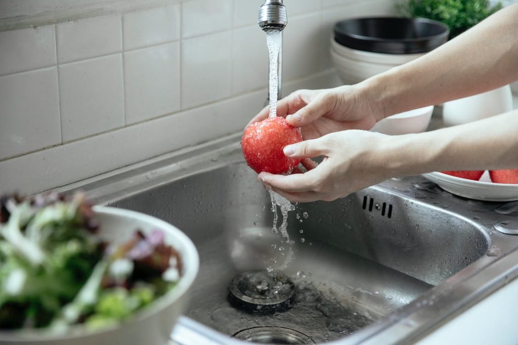 washing a fruit in a sink