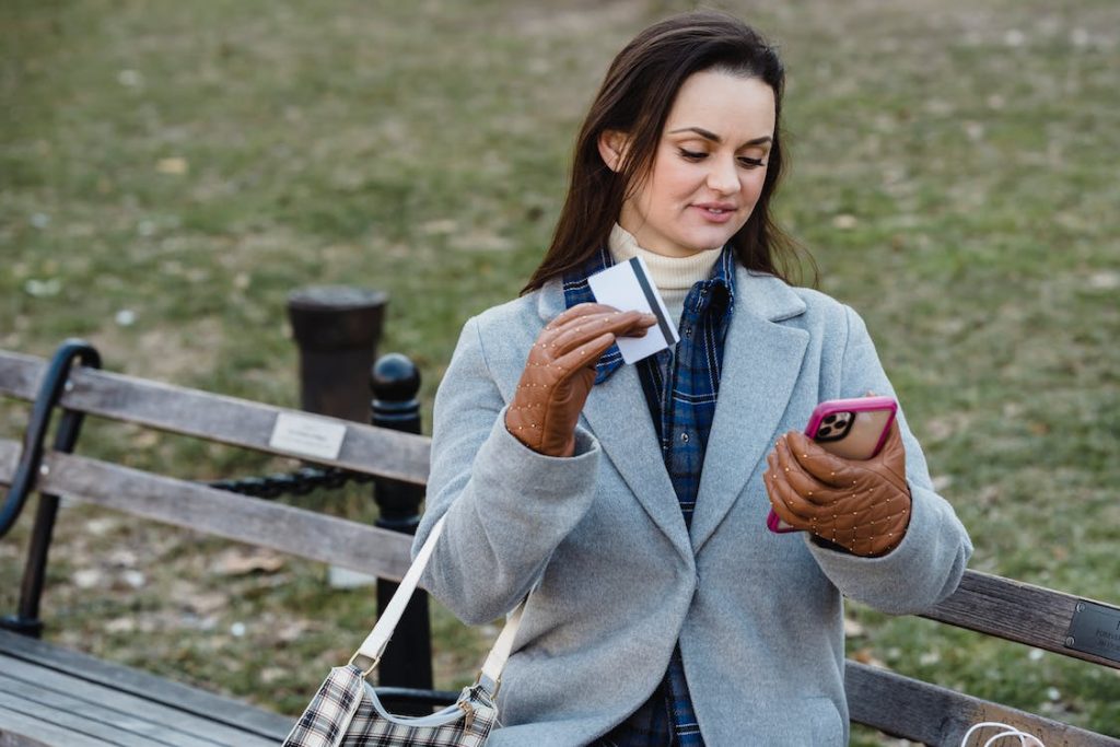 woman paying via card using a mobile phone