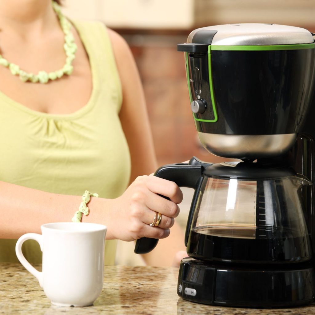 woman using coffee maker