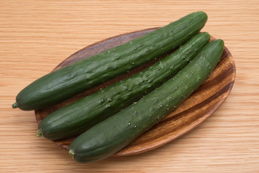 Japanese cucumbers on a wooden plate.