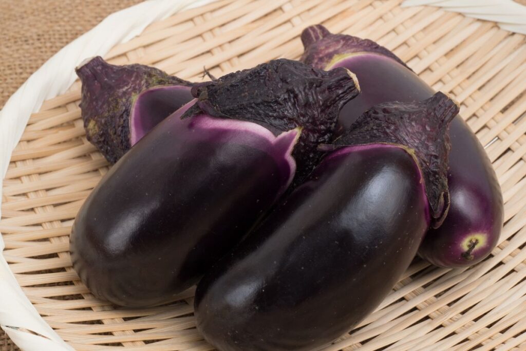 Japanese eggplants in a wooden basket