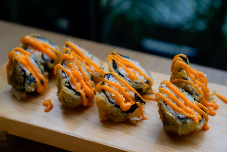 Japanese mayonnaise drizzled on top of sushi.