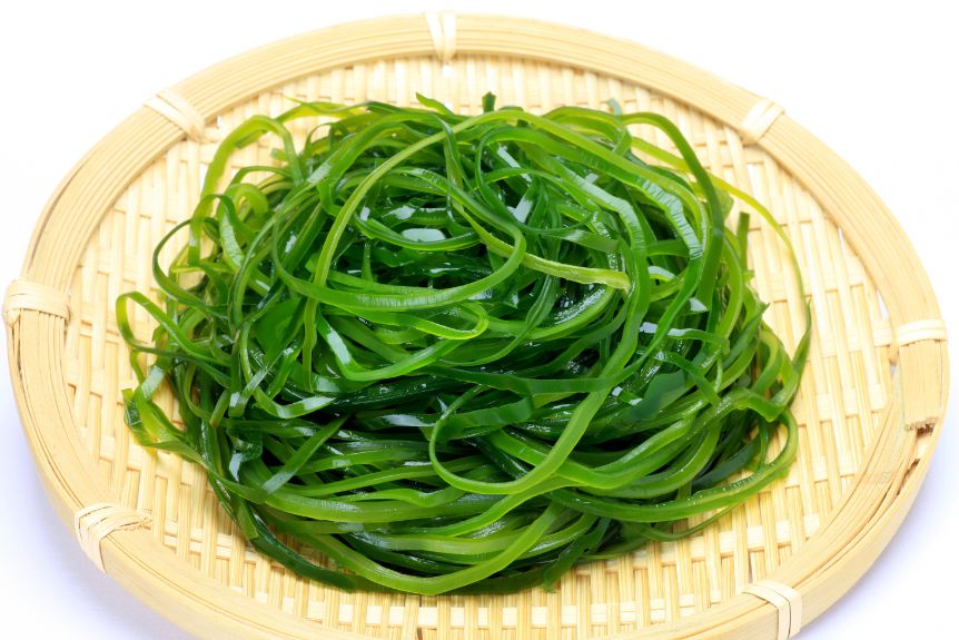 Sliced and boiled kombu seaweeds in a wooden plate.