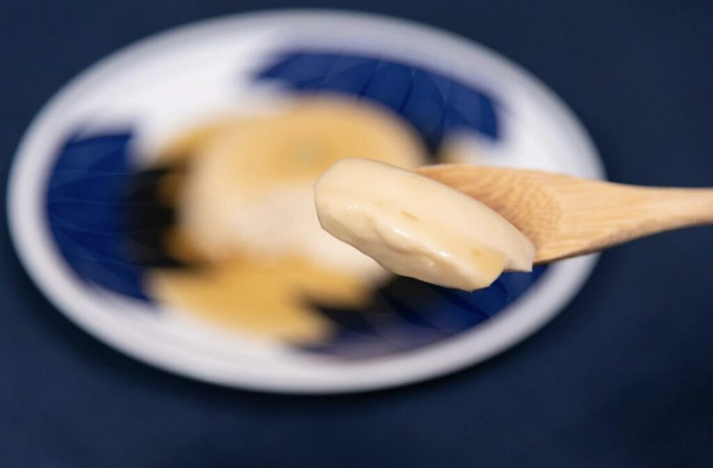 scooping black sesame tofu